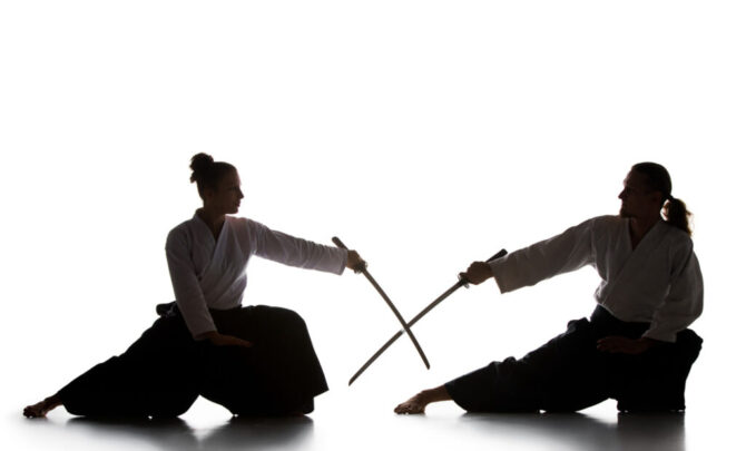 young-man-are-training-aikido-studio-with-saberaikido-master-practices-defense